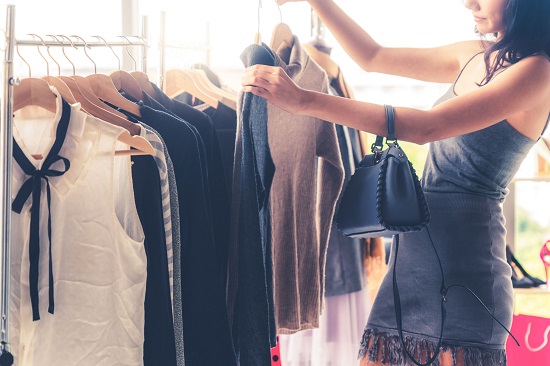 beautiful woman shops for clothes in shopping mall